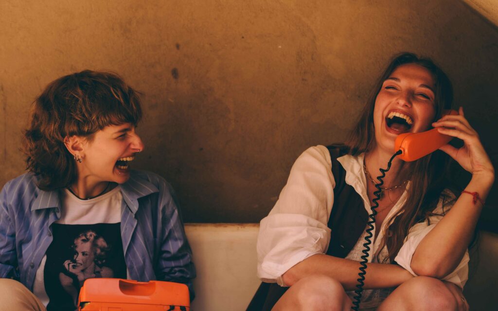 Lachen und ein aktive soziales Leben als Longevity-Treiber, zwei Mädchen lachen